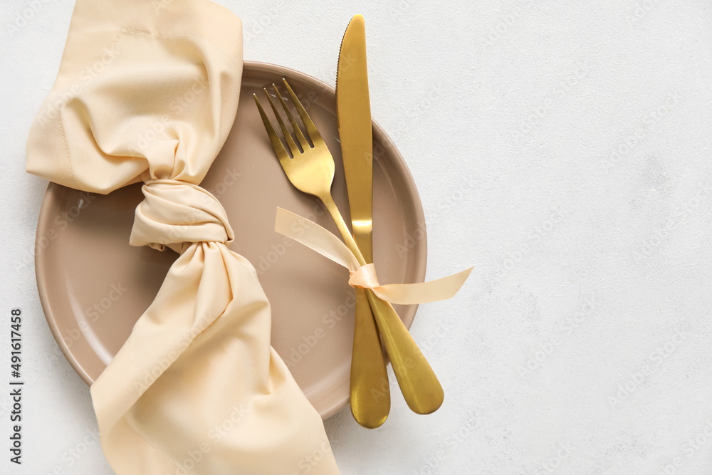 Simple beautiful table setting on light background Simple beautiful table setting on light background