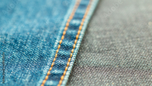 Detail of denim fabric and double stitched. weathered denim fabric.. the selected focus point