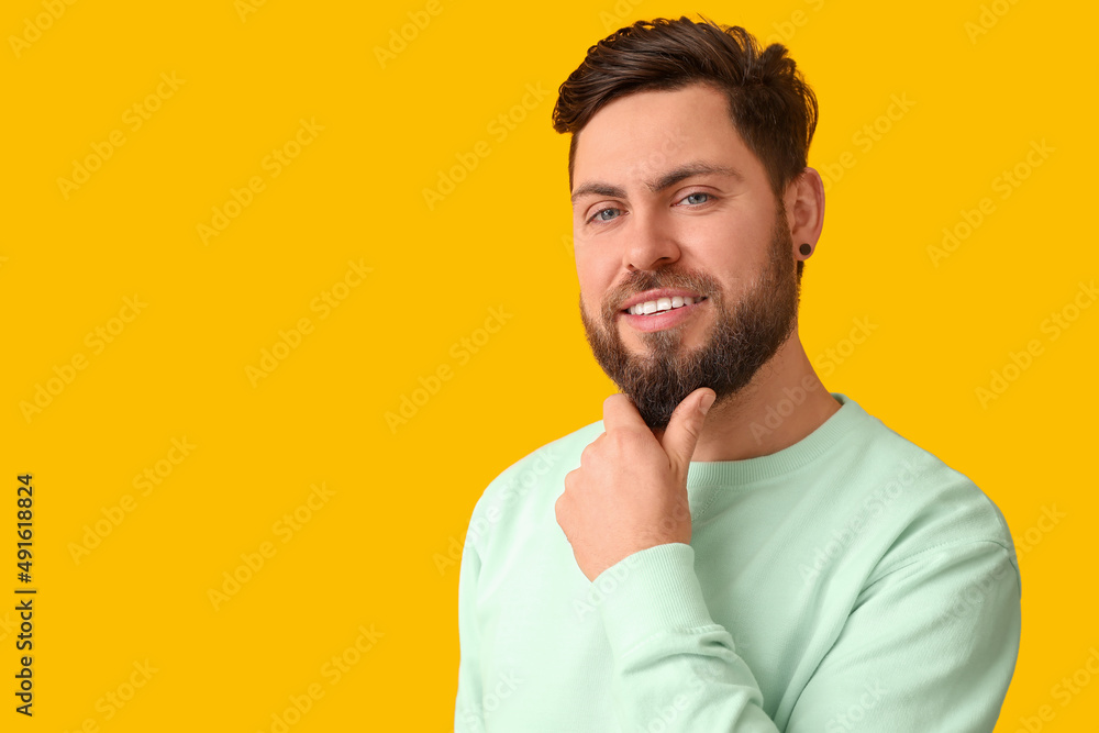 Stylish bearded man on yellow background Stylish bearded man on yellow background