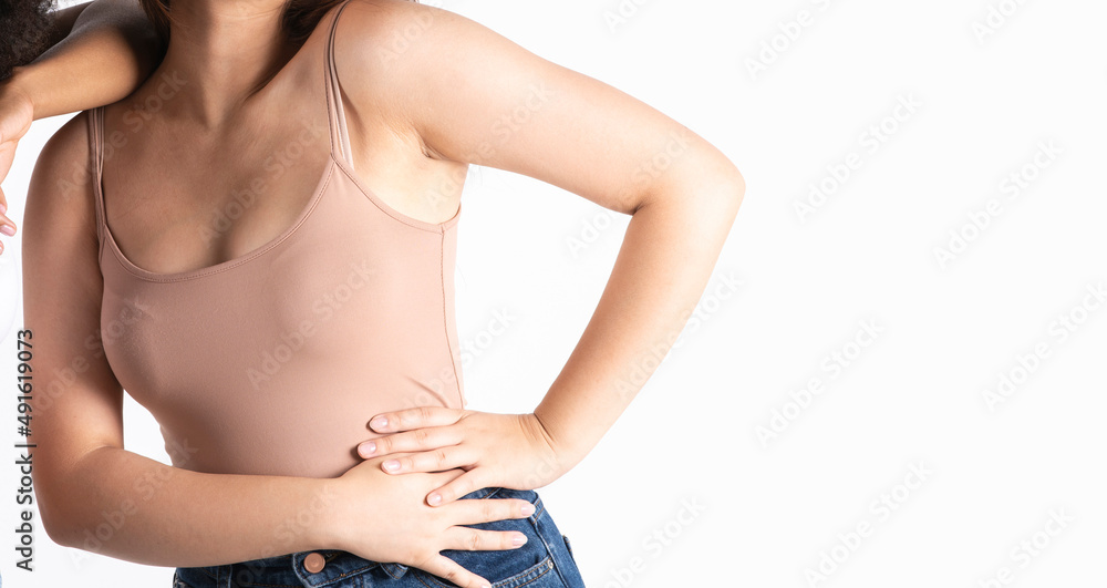 A faceless female model with a slim figure in brown underwear with jeans, healthy skin body care, white background