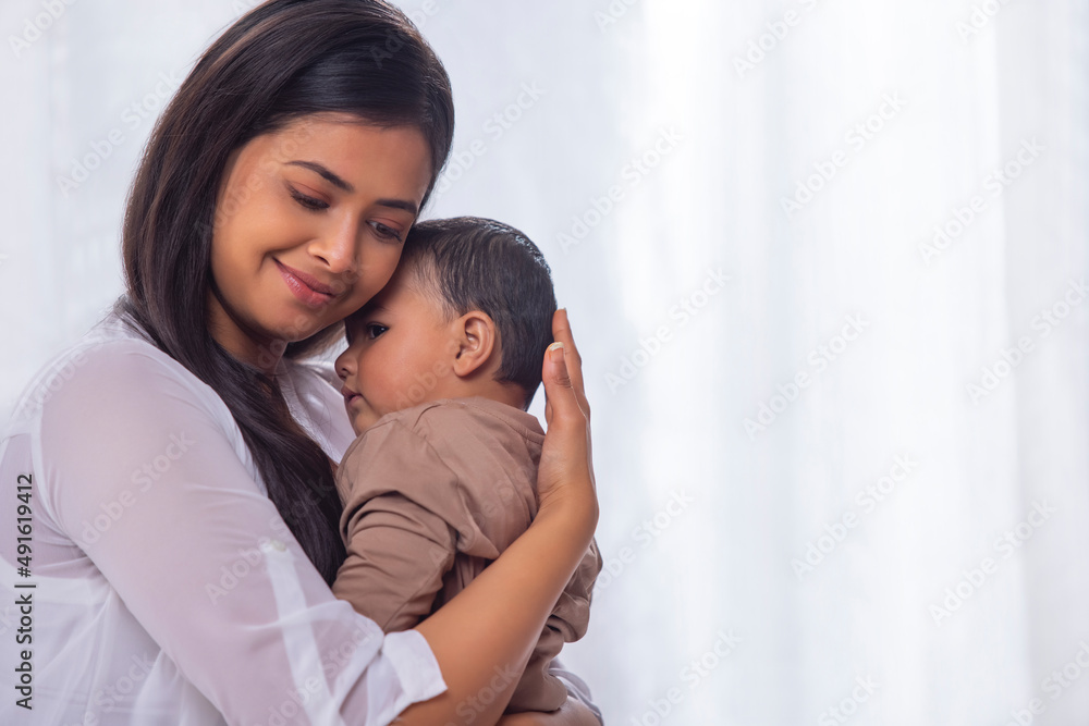 Portrait of happy mother caressing her little baby at home Portrait of happy mother caressing her little baby at home