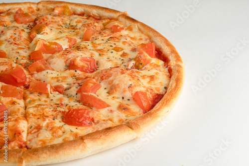 Pizza with tomatoes, oregano and cheese on a white background