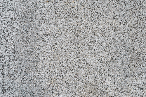 Close-up. Surface texture of natural gray granite material with mineral stone. Abstract Background Empty Seamless. View from above.