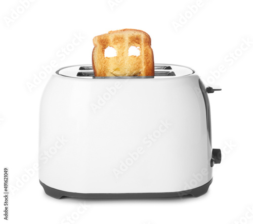 Funny slice of bread in toaster on white background