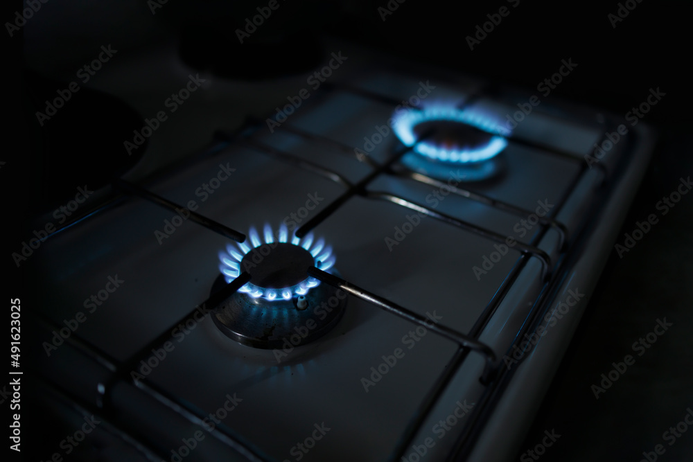 Two gas burners alight while the power is out due to restrictions Two gas burners alight while the power is out due to restrictions