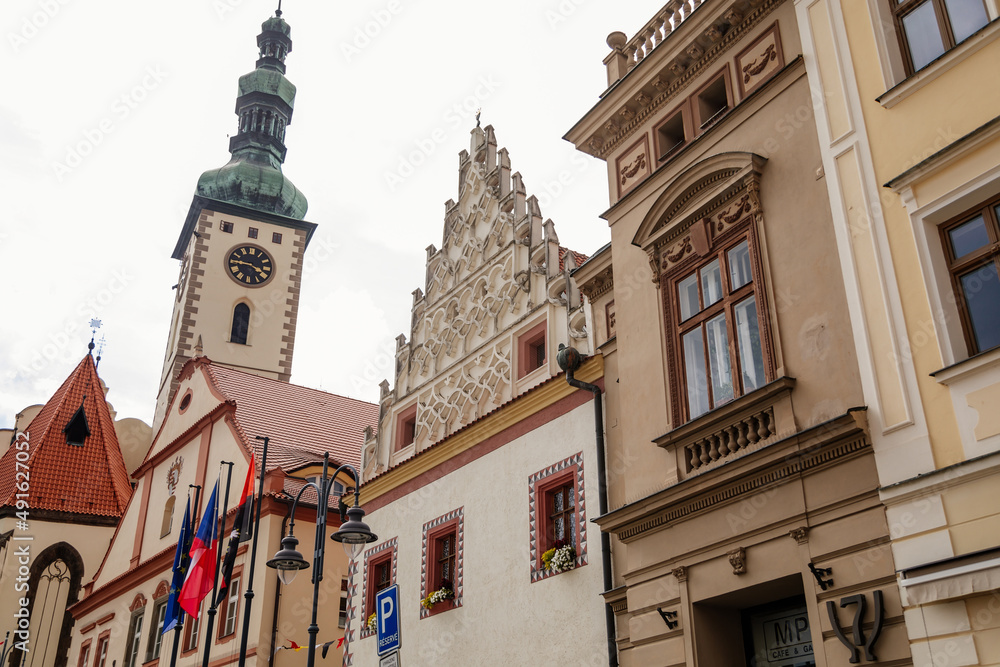Tabor, South Bohemia, Czech Republic, 29 August 2021: Clock bell tower of gothic Church of Transfiguration on Mount on main Square of Jan Zizka near town hall, cityscape of medieval town, summer day