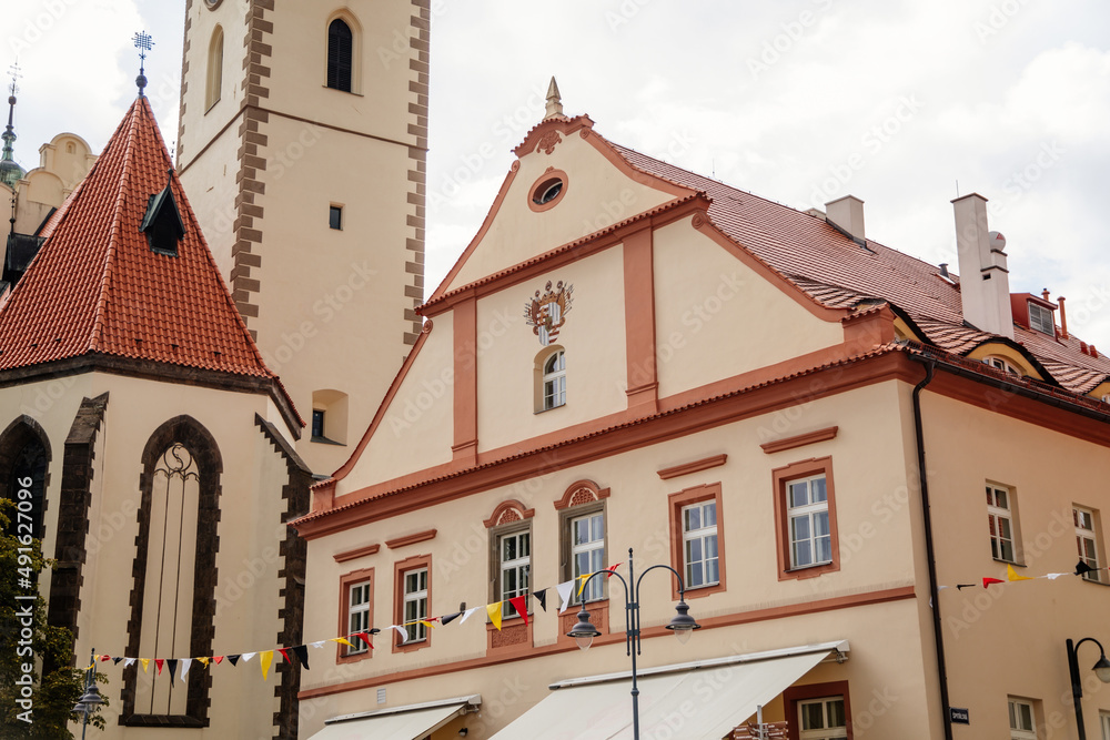 Tabor, South Bohemia, Czech Republic, 29 August 2021: Clock bell tower of gothic Church of Transfiguration on Mount on main Square of Jan Zizka near town hall, cityscape of medieval town, summer day