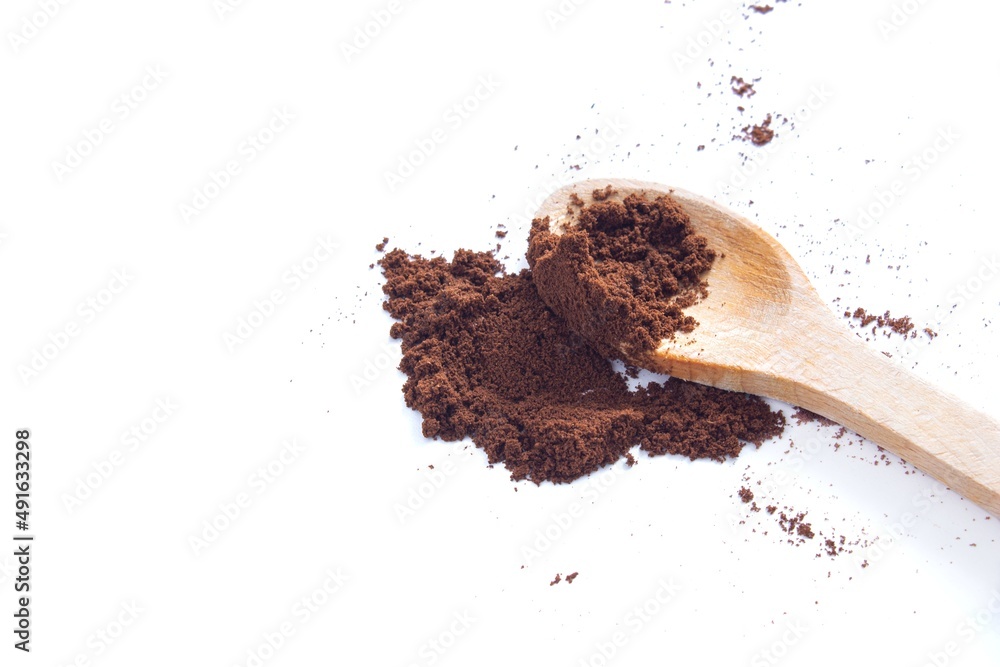 Top view coffee powder with wooden spoon isolated on white background. Top view coffee powder with wooden spoon isolated on white background.
