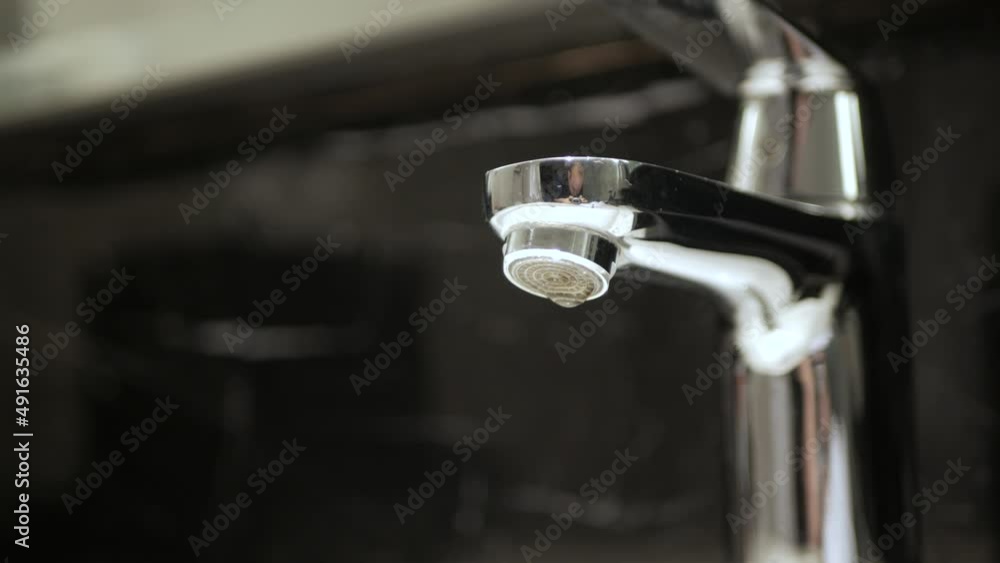 Broken faucet in the tub dripping leak tap water. Broken faucet in the tub dripping leak tap water.