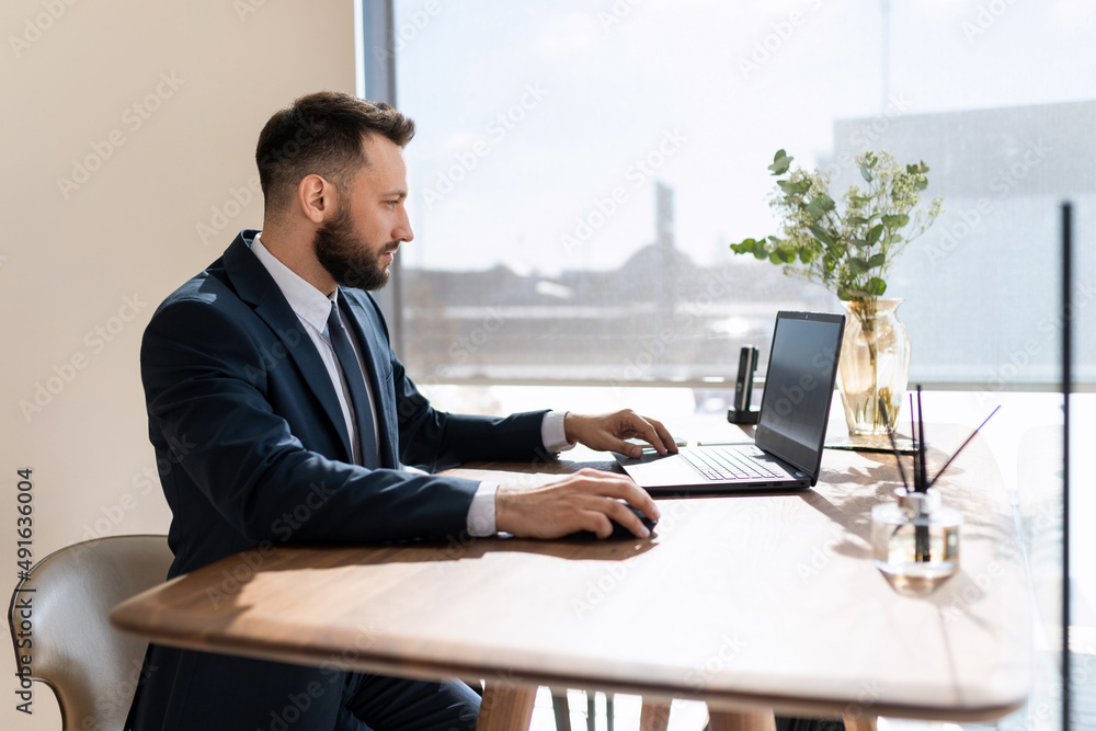 businessman working on laptop in stylish modern office businessman working on laptop in stylish modern office