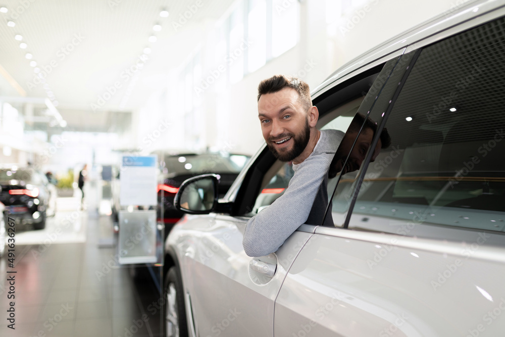 sales manager in a car dealership hands over the keys and documents to the car sales manager in a car dealership hands over the keys and documents to the car