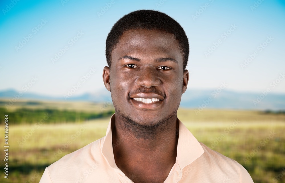Happy young man smiling in camera on the outdoor background Happy young man smiling in camera on the outdoor background
