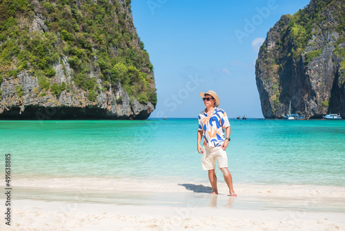 happy tourist man at Maya Bay beach on Phi Phi island, Krabi, Thailand. landmark, destination Southeast Asia Travel, vacation and holiday concept