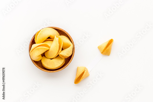 Many Chinese New Year fortune cookies in bowl. Asian New Year background © 9dreamstudio