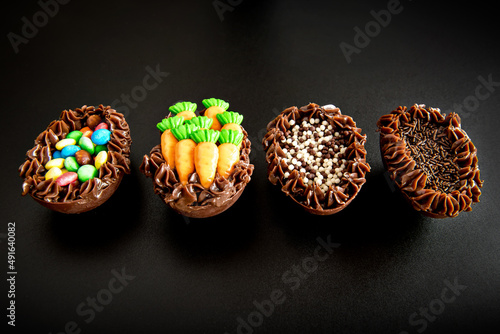 Easter eggs filled with brigadeiro on black background, easter concept.