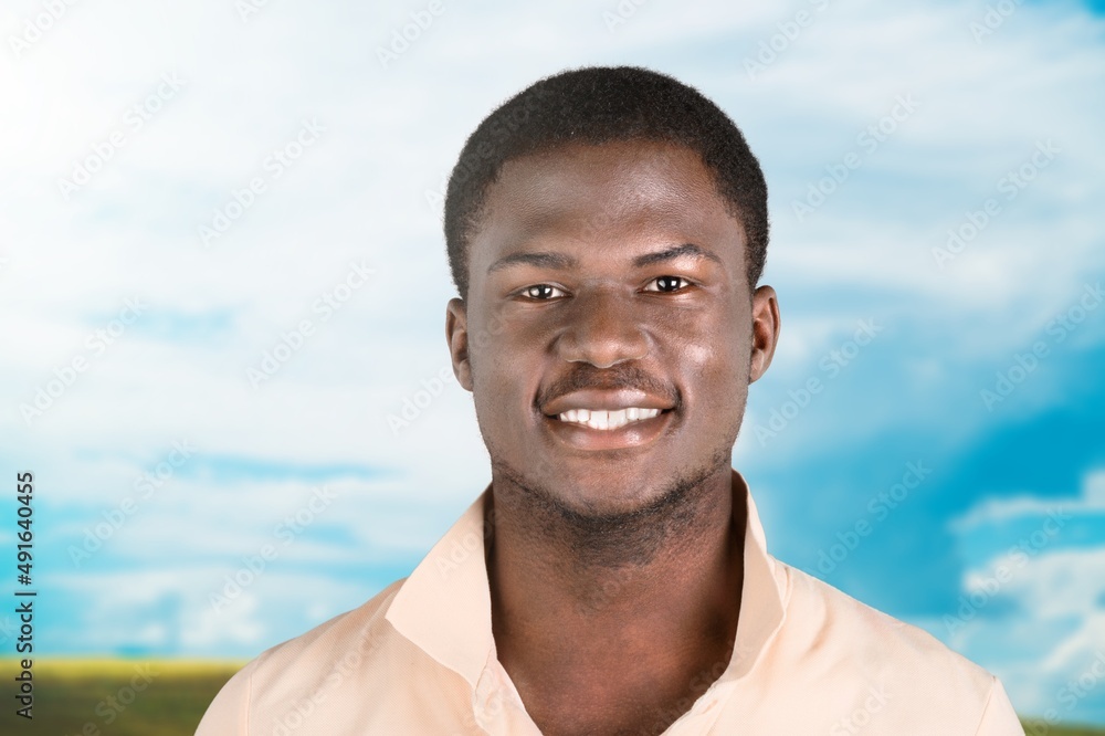 Happy young man smiling in camera on the outdoor background Happy young man smiling in camera on the outdoor background