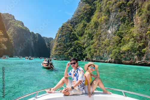 Couple tourist on boat trip, happy travellers relaxing at Pileh lagoon on Phi Phi island, Krabi, Thailand. Exotic, honeymoon, love, destination Southeast Asia Travel, vacation and holiday concept © Jo Panuwat D