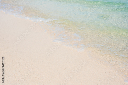Soft wave of blue sea water and white sand at Beautiful beach. Background, wallpaper and abstract concept