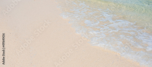 Soft wave of blue sea water and white sand at Beautiful beach. Background, wallpaper and abstract concept © Jo Panuwat D
