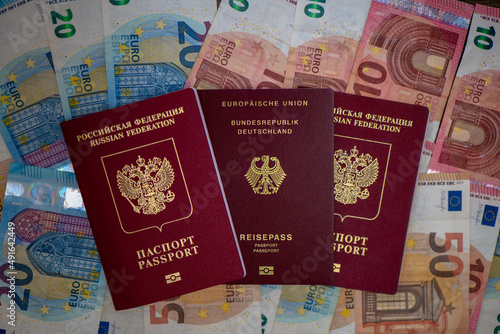 German and Russian passports on euro money bills