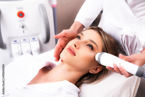 The procedure of rejuvenation of the female face rf-lifting photo. Skin care with radiofrequency lifting. Modern methods of skin aging treatment in cosmetology.