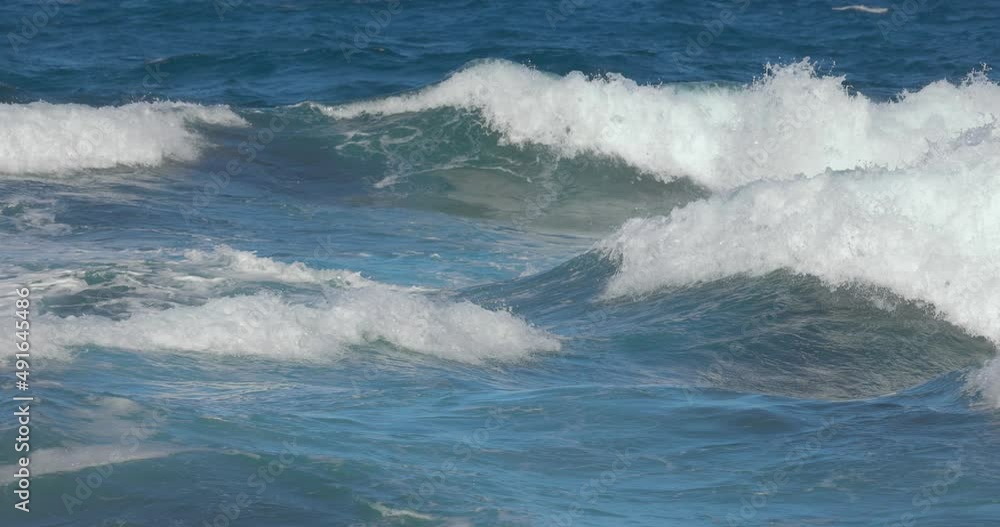 Closeup of backlit colorful blue turquoise wave in slow motion Closeup of backlit colorful blue turquoise wave in slow motion