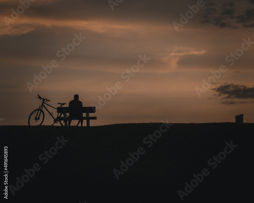 silhouette of a person riding a bike © som