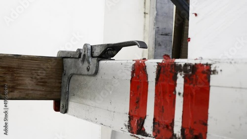 Driver unsecures a truck load cargo using an aluminium bar. Secure cargo fasten