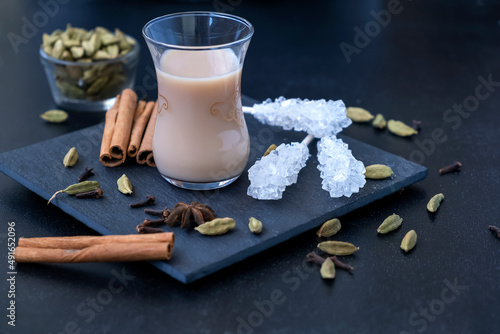 Traditional indian and middle eastern hot drink masala tea or karak chai with spice and milk. Exotic cuisine.