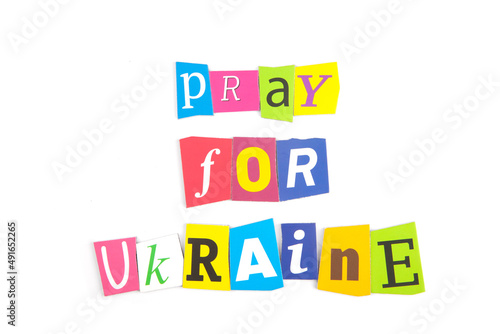 The phrase  Pray for Ukraine  from multi-colored magnetic letters on a white background.