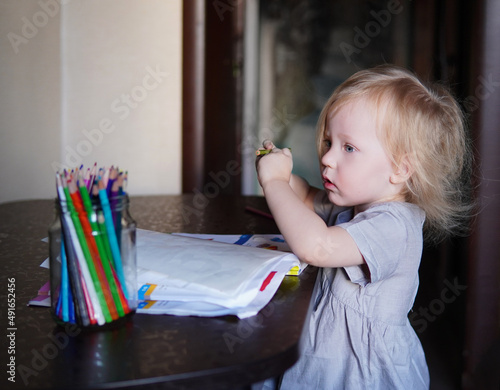 little child drawing with pencils