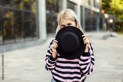 Emotional charismatic girl with hat. Young woman in stylish clothes outdoors
