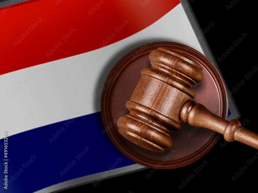 Judge Gavel and flag of Netherland. Law and justice. Violation of rights and freedoms.