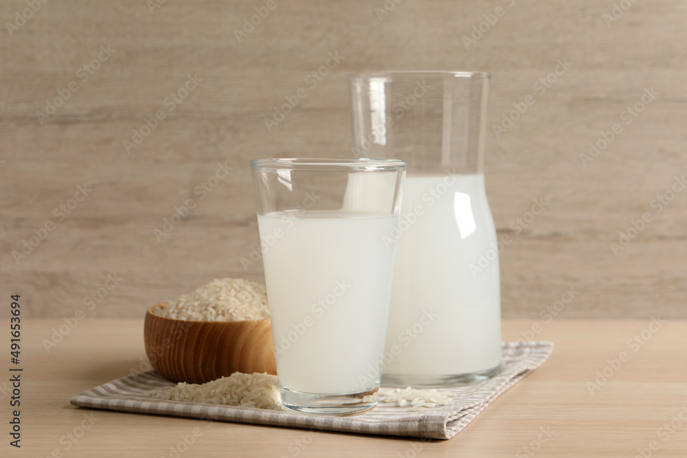 Natural rice water and grains on wooden table Natural rice water and grains on wooden table
