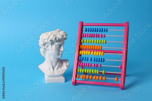 Fotografía Antique David bust with abacus on blue background