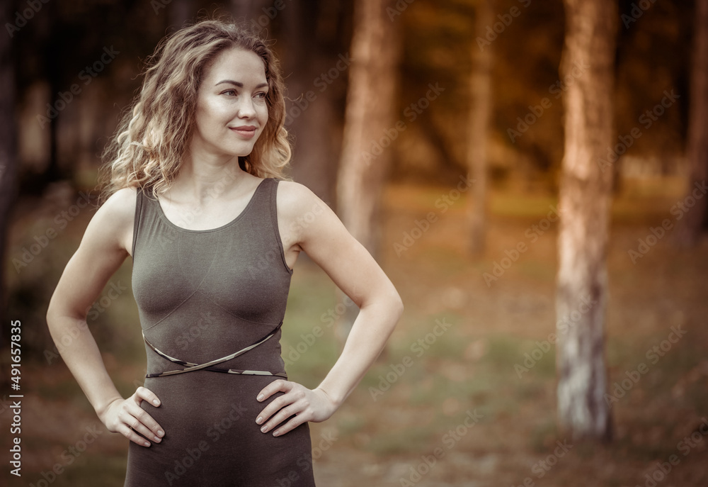 Portrait of a beautiful yoga woman in the park