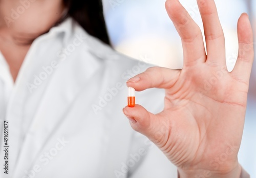 Medical oral capsules, antiviral drug of covid 19 concept in doctors hand.