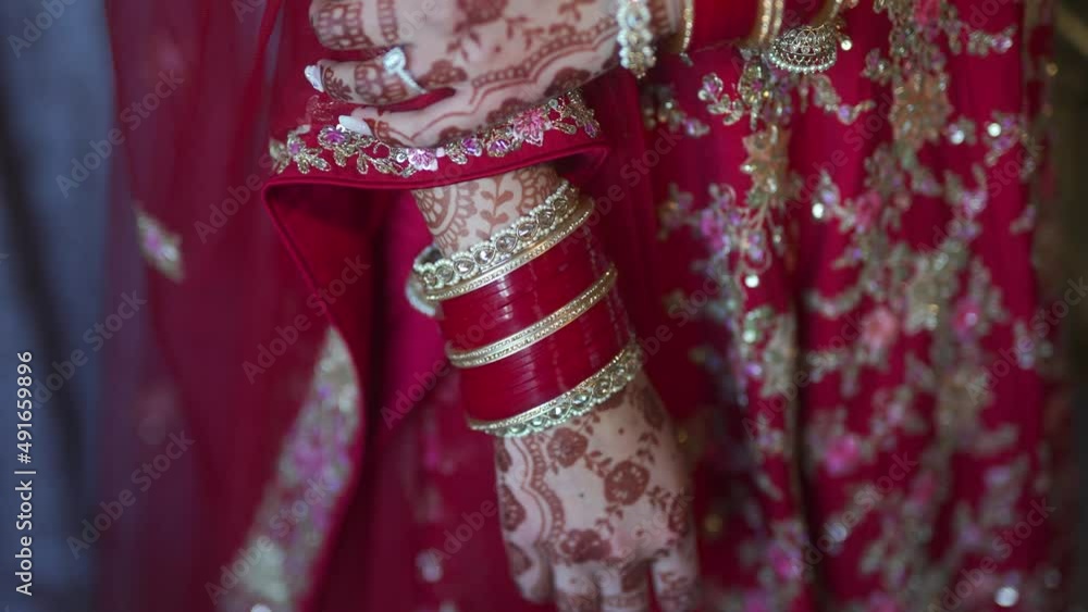 Indian bride with hands tattooed with henna on wedding day. Handheld