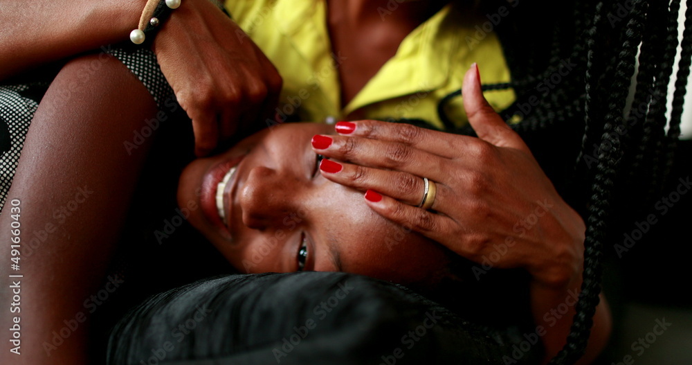 Mother caring and loving teen daughter child. African love and affection