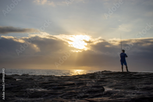 Seascape view with people fishing from the shore line on the South Coast of South Africa © Maryxpix