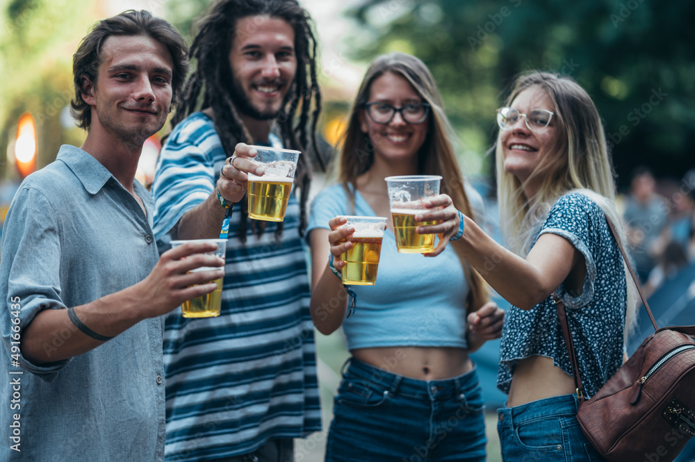 Friends drinking beer and having fun at music festival Friends drinking beer and having fun at music festival