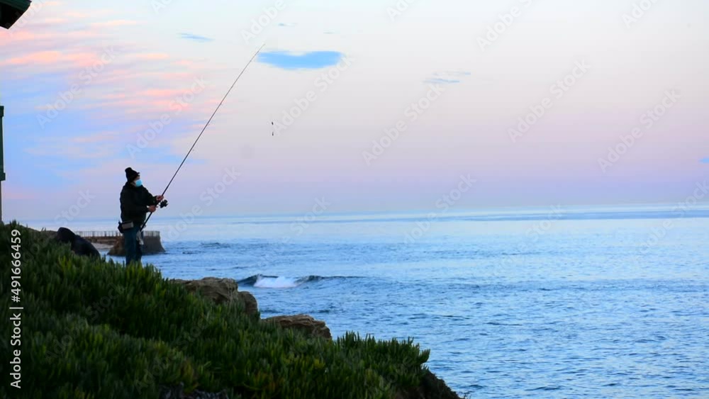 Fisherman Casting Rod into Pacific Ocean at La Jolla California Fisherman Casting Rod into Pacific Ocean at La Jolla California