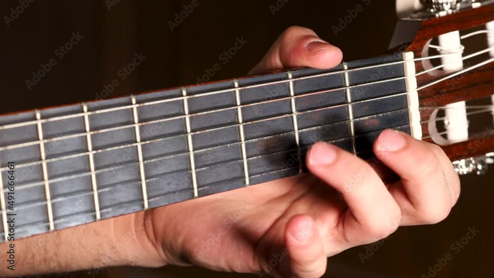 Left guitarist hand pressing strings for chords, close up shot. Left guitarist hand pressing strings for chords, close up shot.
