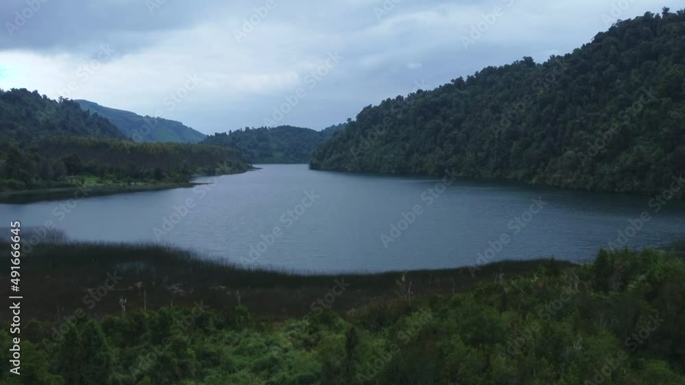 Lagoon surrounded by mountains and forests on cloudy winter days Lagoon surrounded by mountains and forests on cloudy winter days