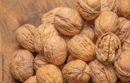 Ripe Walnuts on a wooden table. Walnut fresh nuts Background top view.