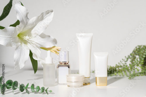 moisturizing cream bottle over leaf background studio, packing and skincare beauty concept