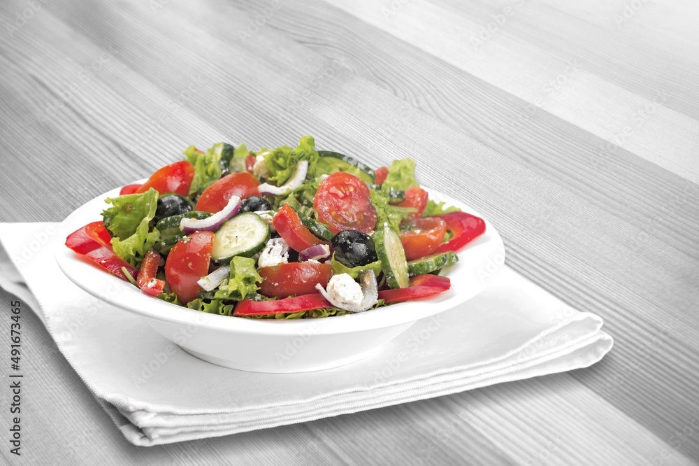 Healthy salad bowl with different lettuce, chicken, cheese on the table in restaurant. Healthy salad bowl with different lettuce, chicken, cheese on the table in restaurant.