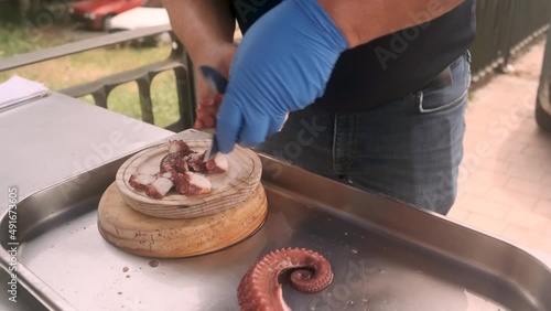 Octopus cooking in a large casserole to prepare the typical dish of Galicia: pulpo a feira photo
