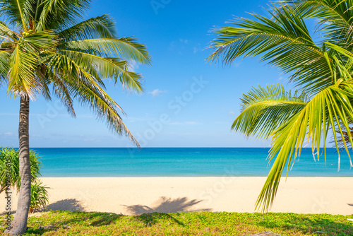 Fototapeta Naklejka Na Ścianę i Meble -  Amazing beautiful Phuket beach with coconut palm trees Thailand Landscapes view of sand beach sea and clear blue sky in summer season At Karon Beach Phuket Thailand