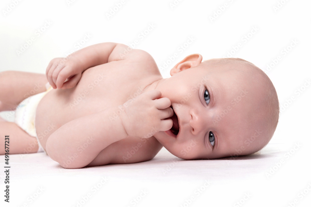 charismatic baby with a smile on his face on a white background puts his fingers in his mouth charismatic baby with a smile on his face on a white background puts his fingers in his mouth